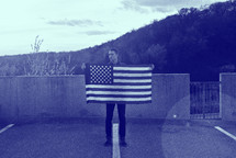 A man holding an American flag 