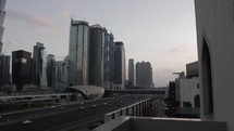 Downtown Dubai with buildings, skyscrapers and cars and traffic driving on Shiek Zayed road in the United Arab Emirates. 