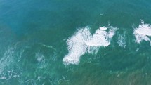 Strong ocean waves vertical aerial view