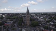 Aerial view of Sint-Vituskerk catholic church in Hilversum, Netherlands, orbiting shot