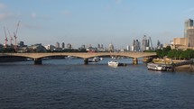 LONDON, UK - CIRCA JUNE 2018: View of Waterloo bridge over river thames and the City skyline at sunset - EDITORIAL USE ONLY