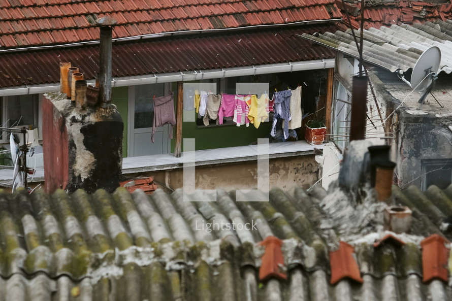 metal shingles on a roof and clothes on a clothesline 
