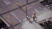 Workers pour concrete on the construction site