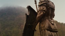 Low angle view of pedestrian statue of roman soldier and the medieval fortress Deva in Transylvania.
