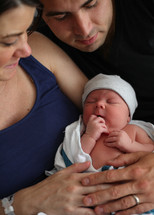 couple holding their newborn son 