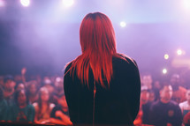 woman on stage at a concert 