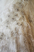 lace and beads on a wedding gown 