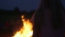Young Woman Walks Toward Bonfire