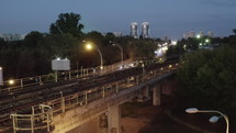 City Skyline With Subway Train Passing by over the bridge overpass. Drone Aerial shot of Business city skyscraper towers on the background.