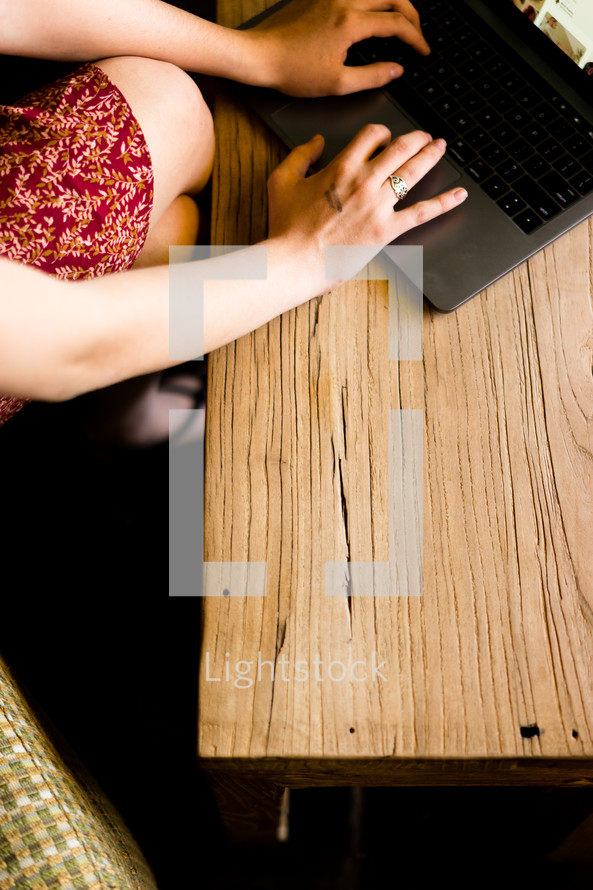 a woman typing on a laptop computer 