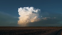 Lone Storm Cloud Builds In The Late Day Sun Over Nice Farm Land Timelapse