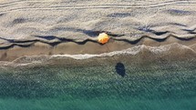 Orange umbrella near the sea at Summer
