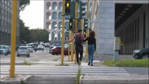 a couple crossing a crosswalk in a city 