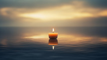 Candle burning in the ocean with sun light