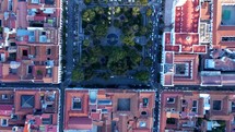 Aerial shot drone with camera facing down flies over main square in city