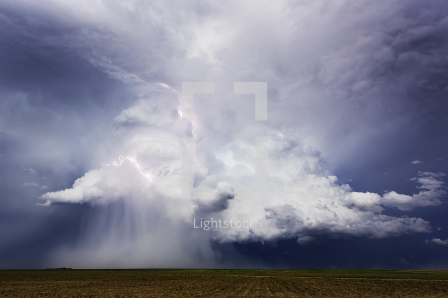 Supercell Storm Microburst And Lightning Bolt Over Peaceful Fields