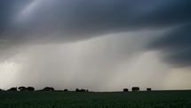 A Heavy Rain Shower Drifting Across Green Farm Land.