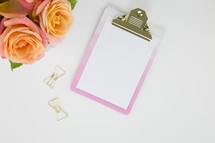 clipboard, flowers, and gold paperclips 