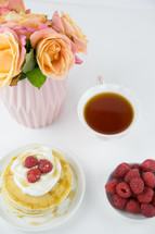 raspberries on pancakes and tea