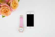 watch, iPhone, and roses in a vase 