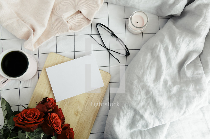 wood board, sweater, roses, sheets, linens, bed, bedding, bedspread, iphone, planner, journal, pencil, reading glasses, candle, coffee mug, grid