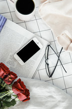 sweater. red roses, coffee mug, reading in bed, reading glasses, iphone, phone, winter, sheets, bed, linens, book, pages