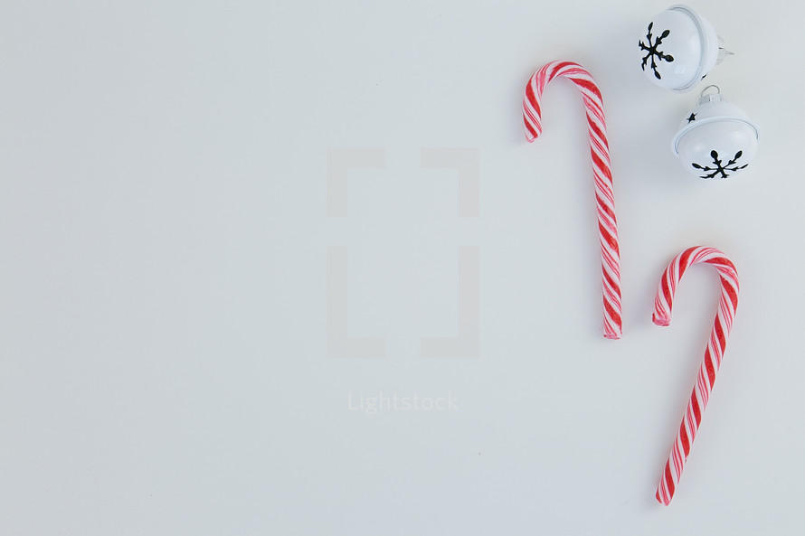 bells and candy canes on white background 