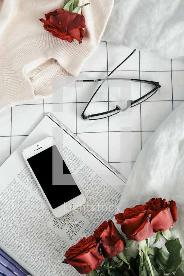 sweater. red roses, pages, book, reading in bed, reading glasses, iphone, phone, winter, sheets, bed, linens