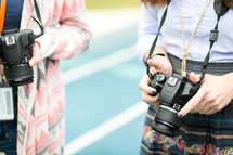 photographers holding cameras