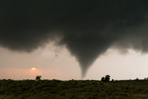 A Tornado With The Setting Sun In The Background