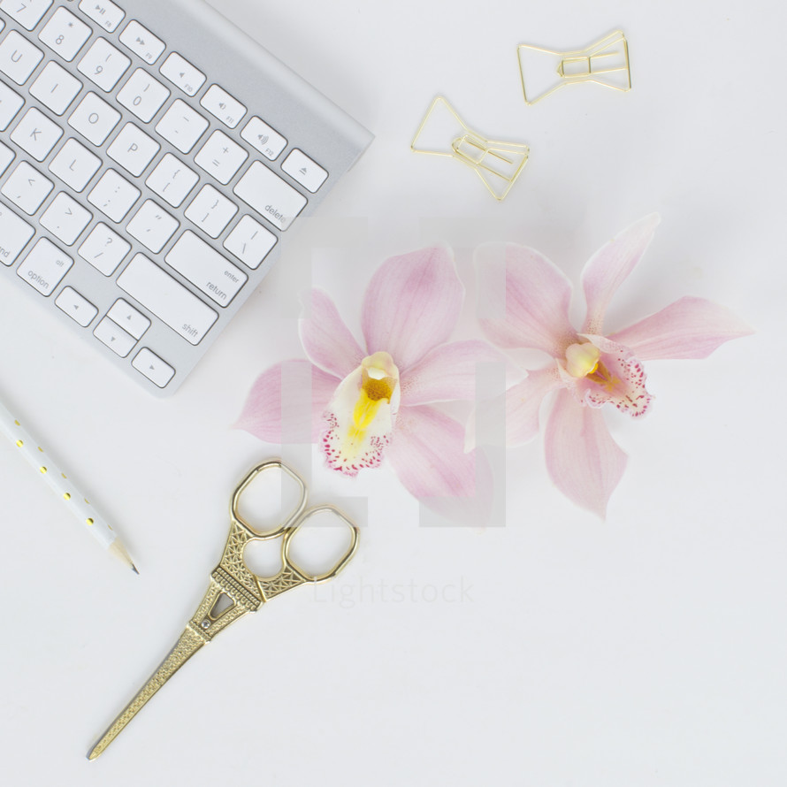 eiffel tower, gold, clips, scissors, keyboard, pencils, keypad, computer, desk, white background, orchids, pink 
