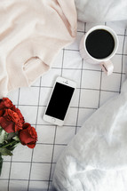 sweater. red roses, coffee mug, reading in bed, reading glasses, iphone, phone, winter, sheets, bed, linens