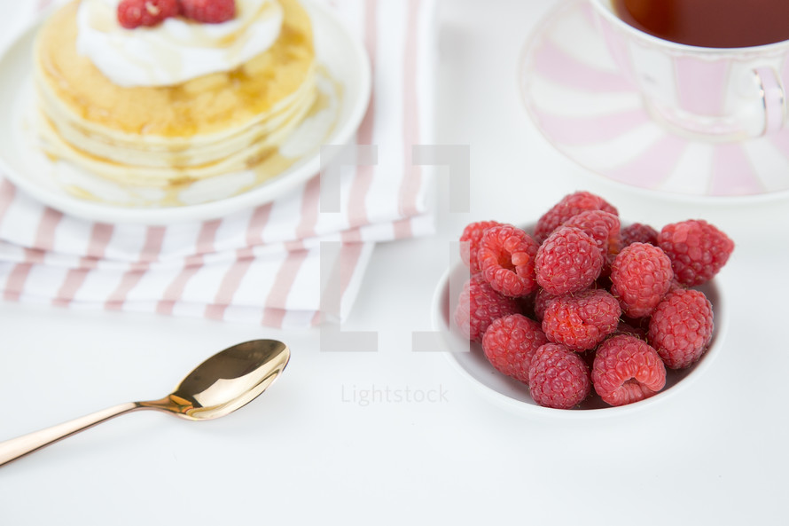 raspberries on pancakes and tea 