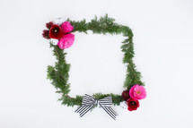frame of pine and flowers and Christmas bells