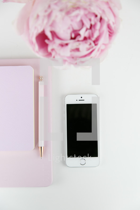 iPhone, pen, journal, and pink peony on a white background 