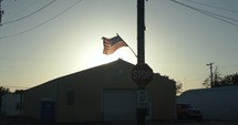 USA, United States American flag flying, blowing in wind on 4th of July in slow motion.