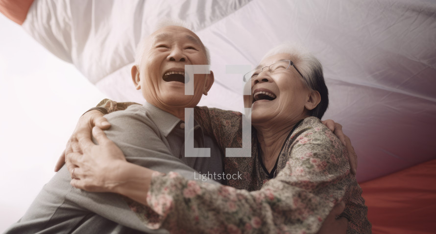 AI Generated Image. Happy Asian Senior elderly couple hugging against the parachute