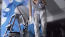 Talented woman artist painting blue ink art blur
