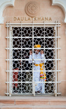 a man looking through a gate in India 