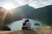 couple snuggling looking out at Diablo Lake 