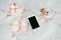 Christmas ornaments and iPhone on marble 