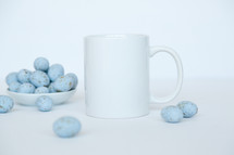 speckled blue eggs in a bowl and a coffee mug 
