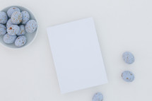 speckled blue eggs in a bowl and white paper 