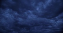 Dark, blue, moody storm clouds in the sky.