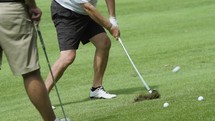Slow motion of a golfer hitting a golf ball.