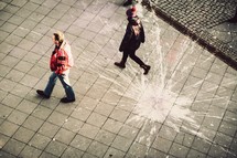 men walking and paint splatter on a  courtyard 