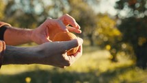 Hand is Peeling a Fresh Orange Fruit From the Tree in the Countryside