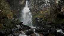 Waterfall Cascading Down Rocks At Cayambe Coca National Park In Papallacta, Ecuador - slow motion	