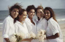 AI Generated Image. Young smiling women in white shirts with bouquets of flowers