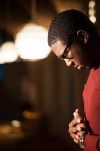 African American, man, reading glasses, head bowed, praying hands, prayer 